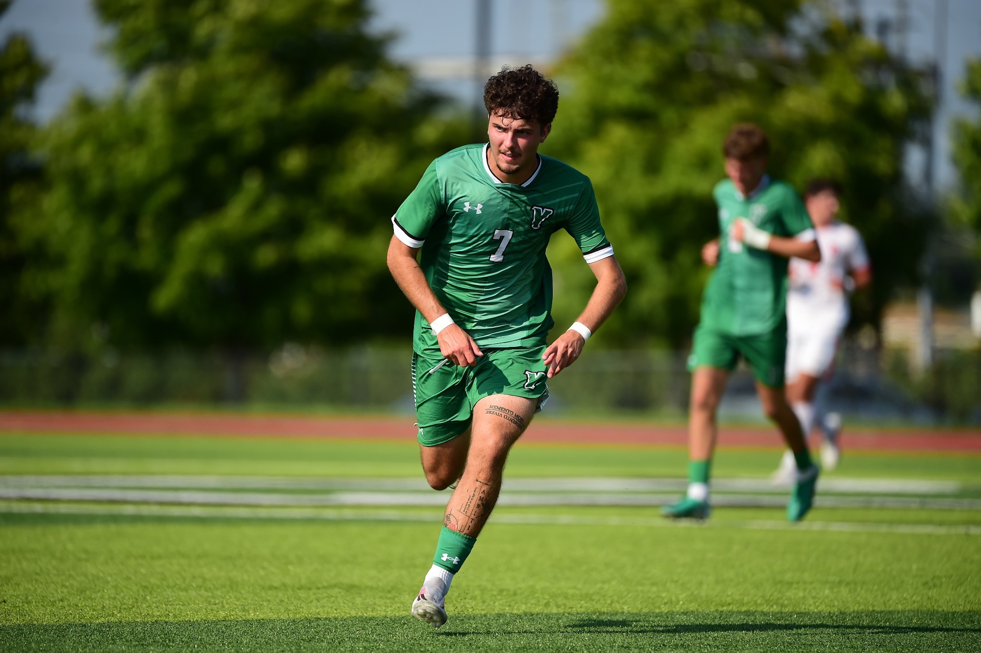 Male running towards soccer ball