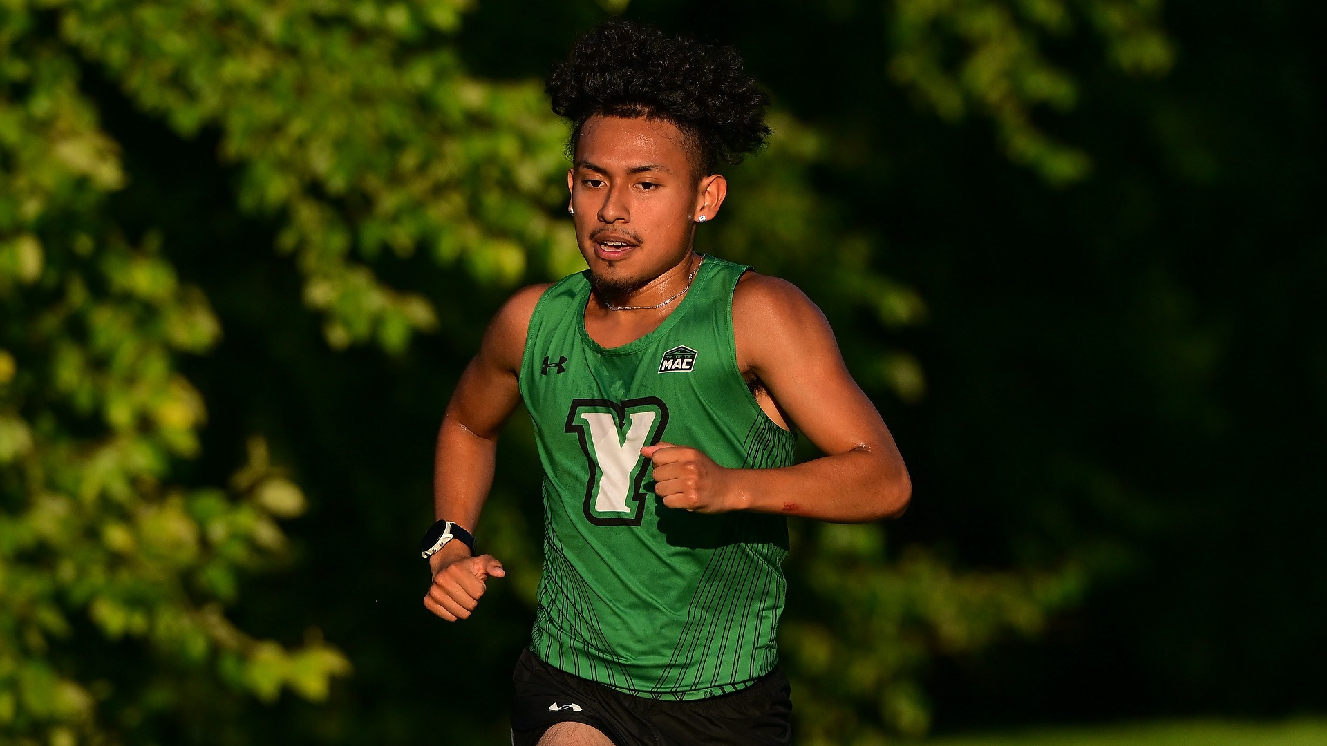 male cross country runner runs around the course in York