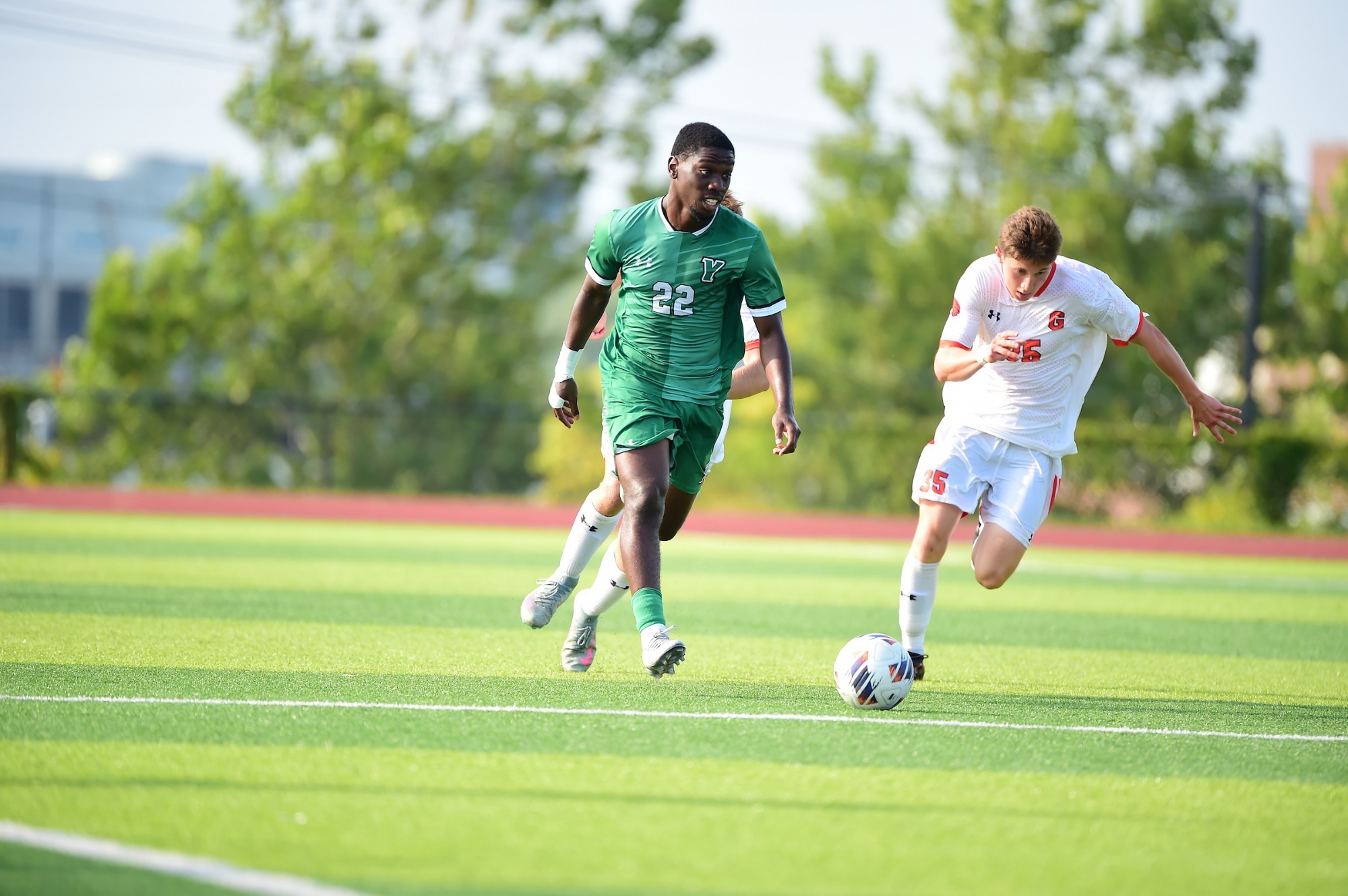 Male dribbling soccer ball