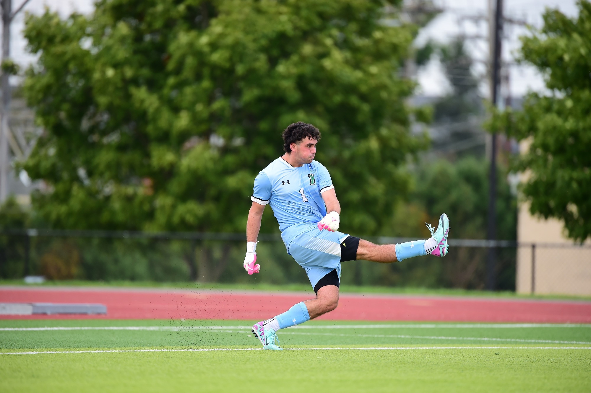 Male punting soccer ball