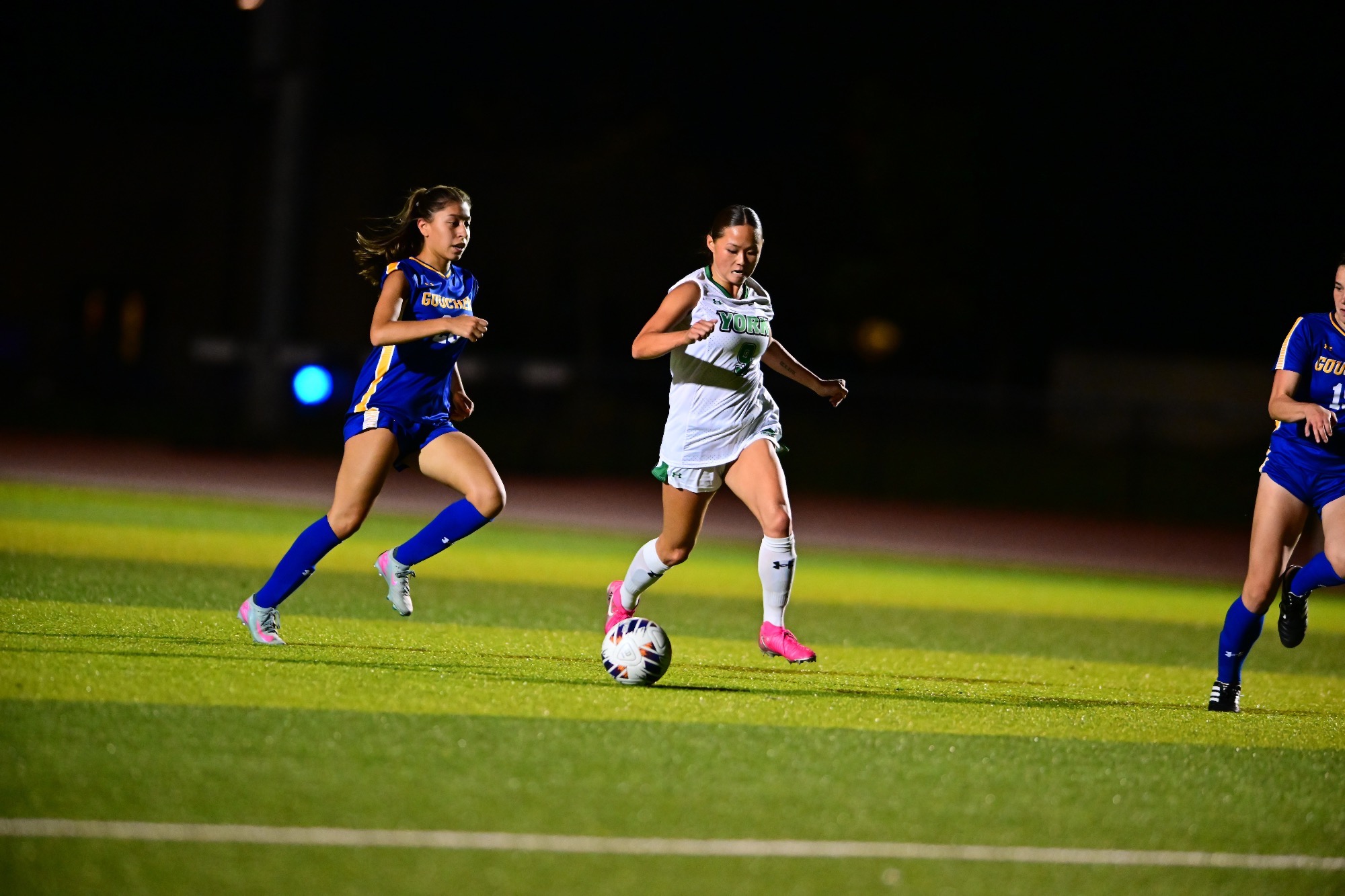 Female running with soccer ball