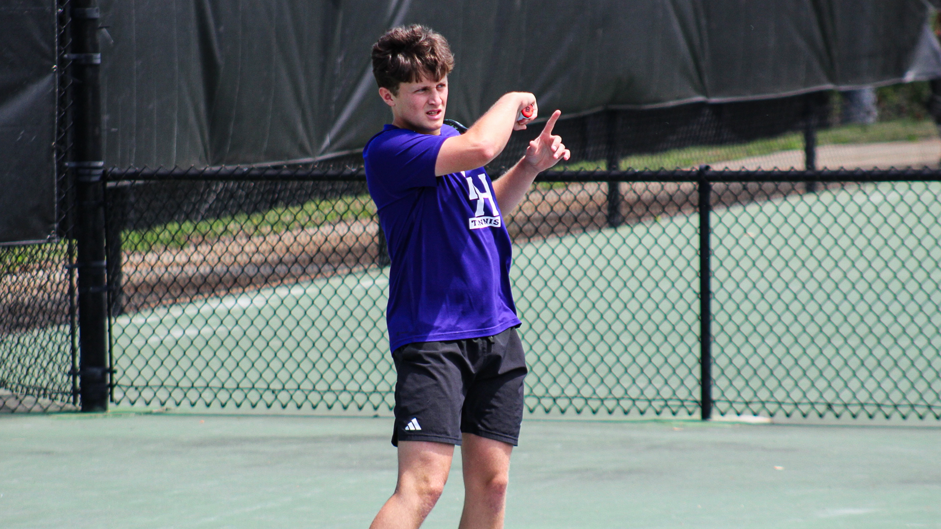 Jamie Bixby Hitting a shot in singles
