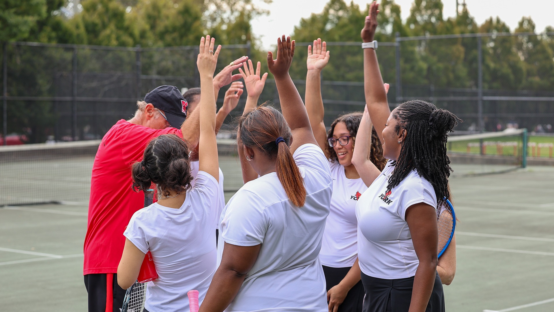 York College Women's Tennis huddles vs. Hunter College (10.1.2026)