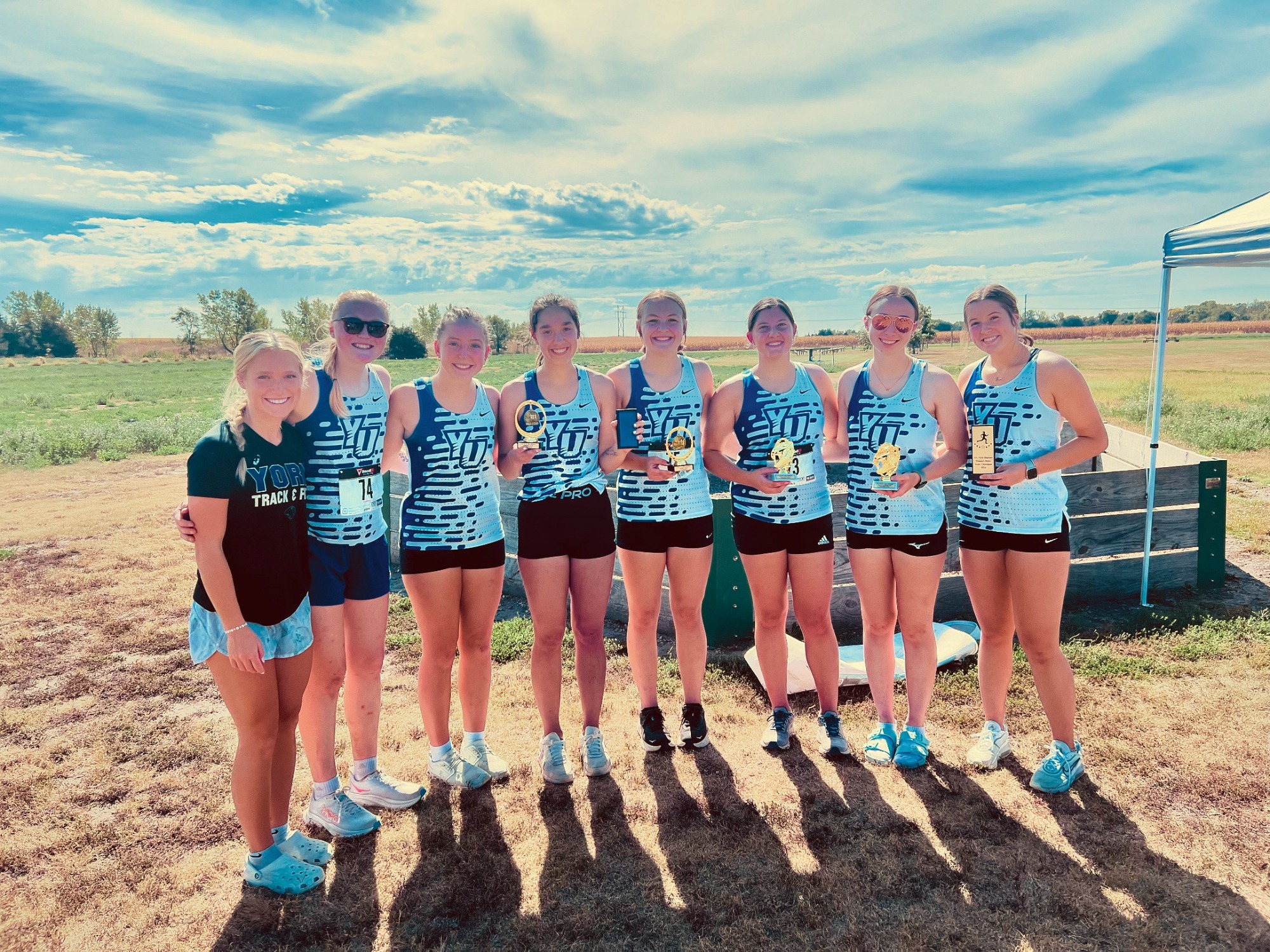 Women's XC posing with trophies