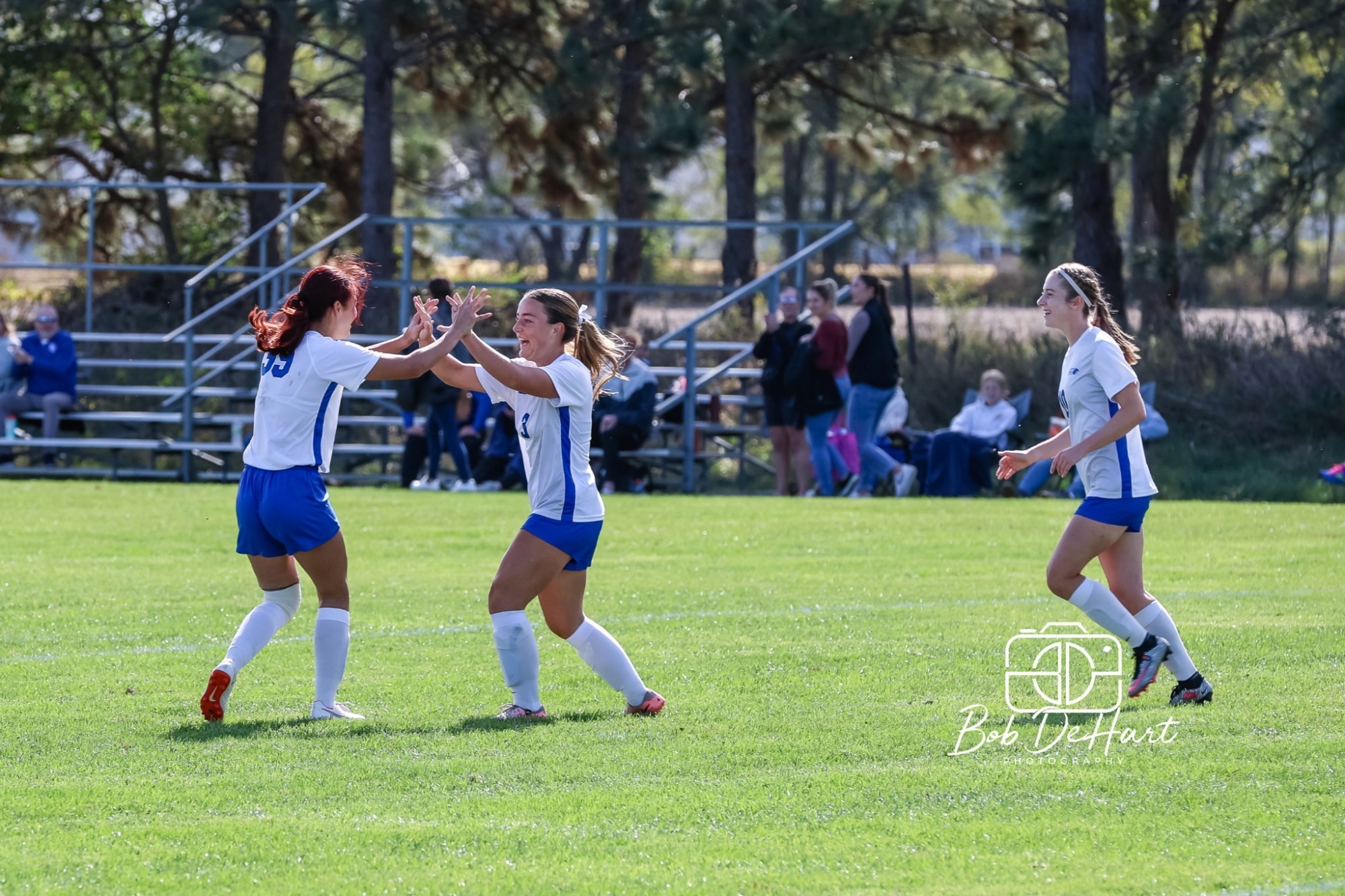 Cornejo and Ellie Reynolds celebrate goal on Homecoming