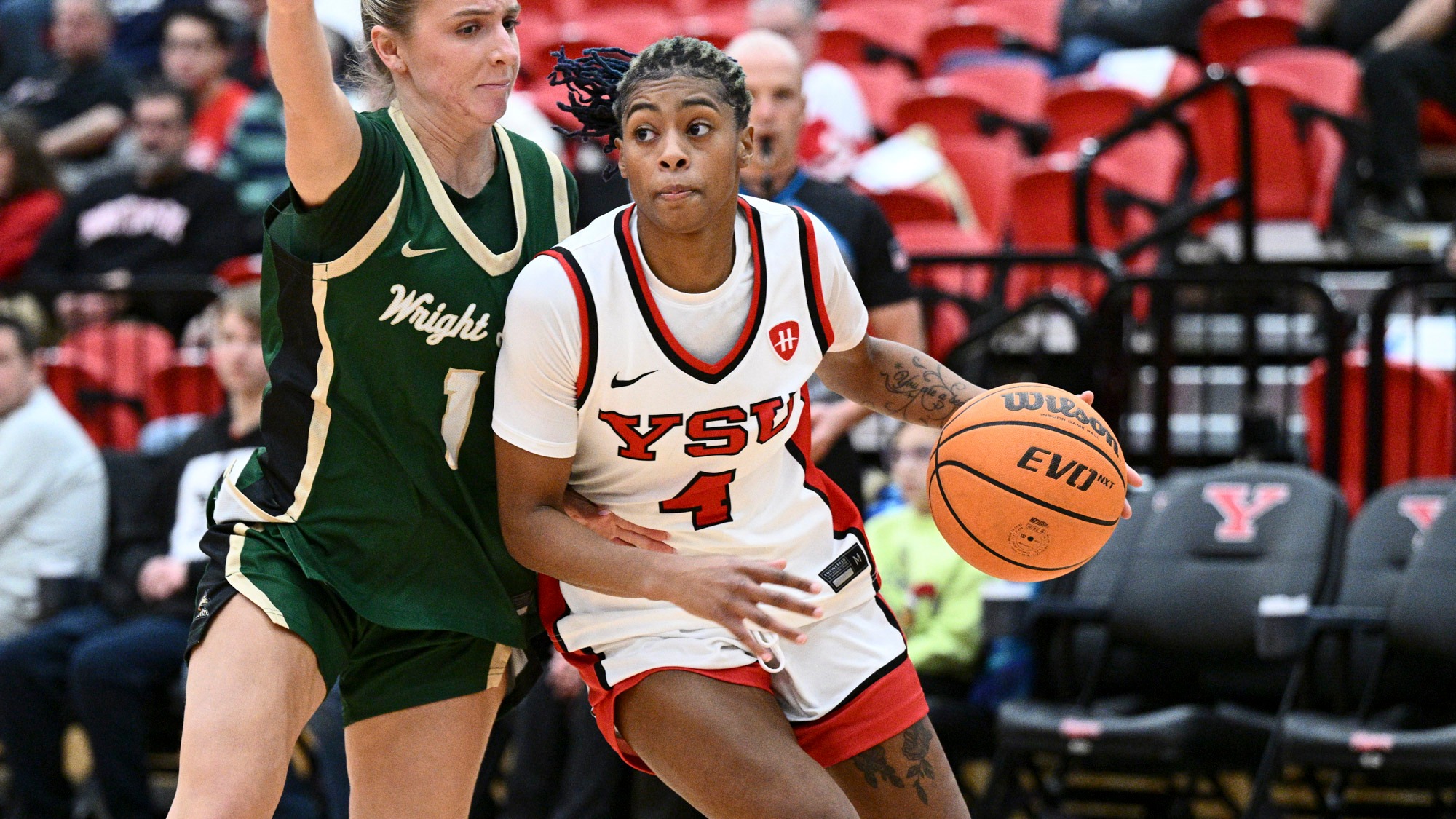 Erica King drives alongside a Wright State defender in Youngstown State's women's basketball game against the Raiders on Dec. 16, 2025. Photo by Robert Hayes.
