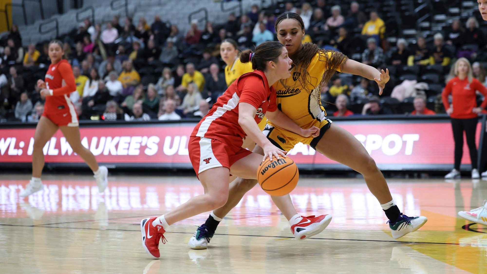 Casey Santoro drives on a Milwaukee defender before scoring her 1,000th career point. Photo by Chloe Whitlock.