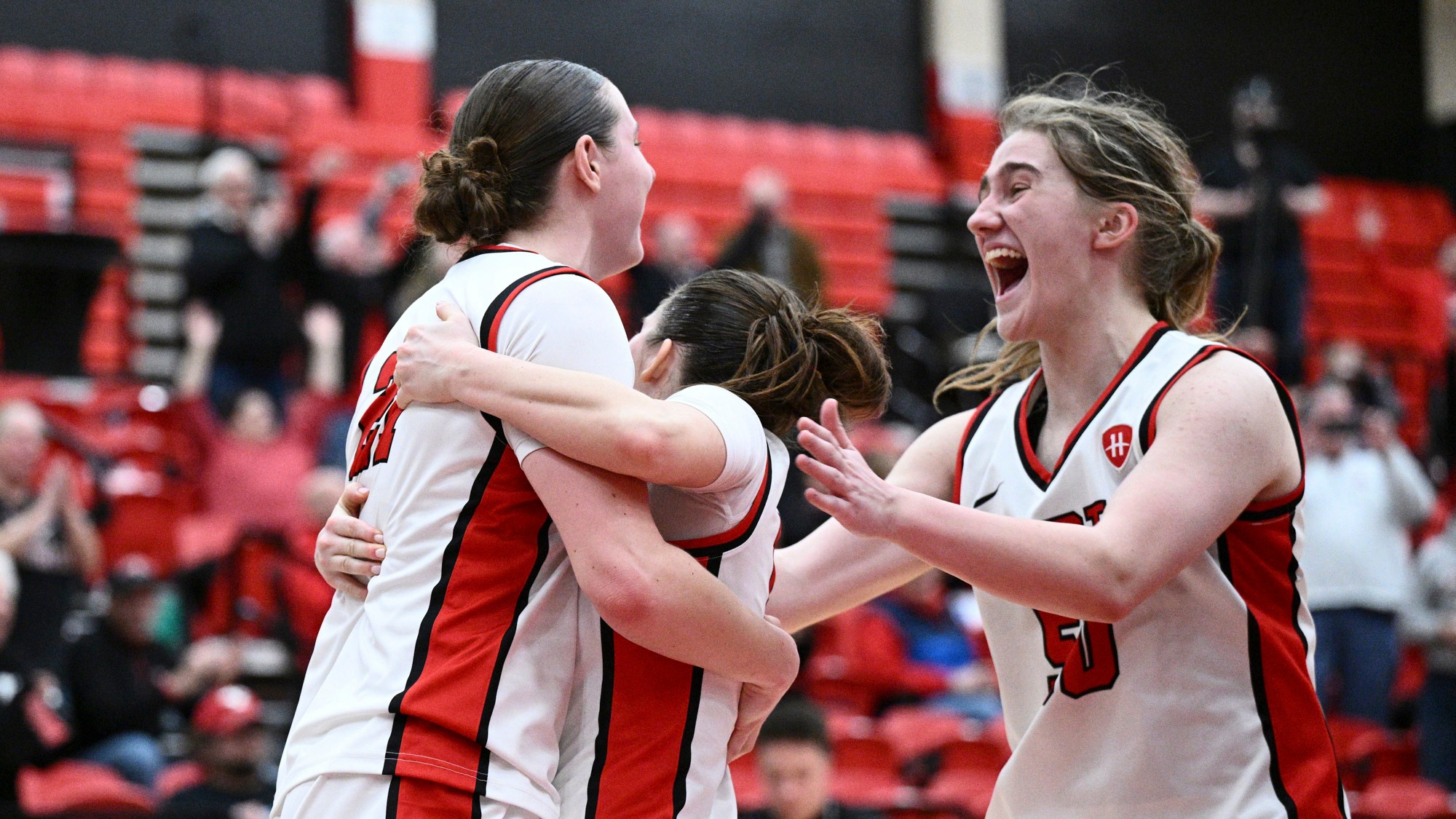 Sophia Gregory is hugged by Casey Santoro as Sarah Baker approaches after Gregory's buzzer-beater. Youngstown State beat RMU 69-62.