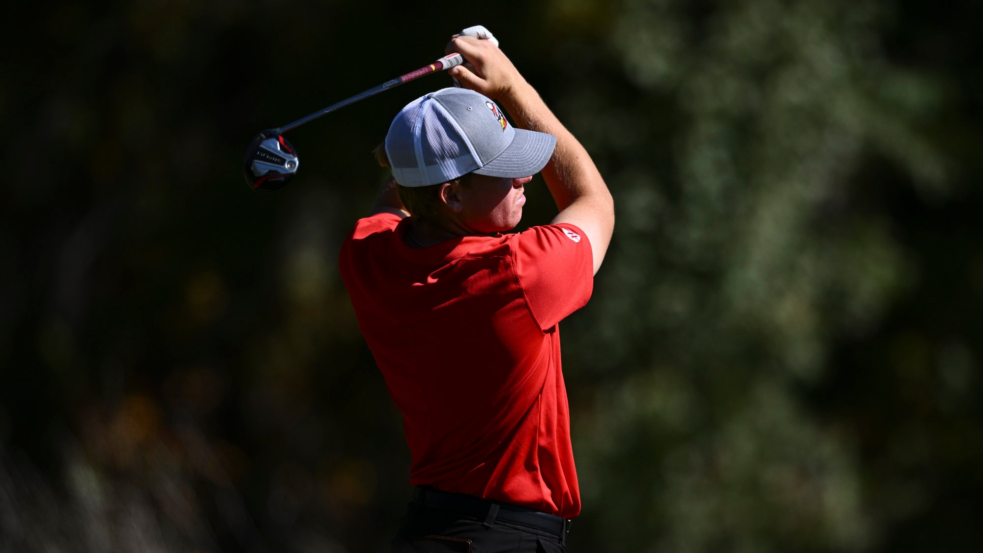 Ryan Sam follows through in his golf swing