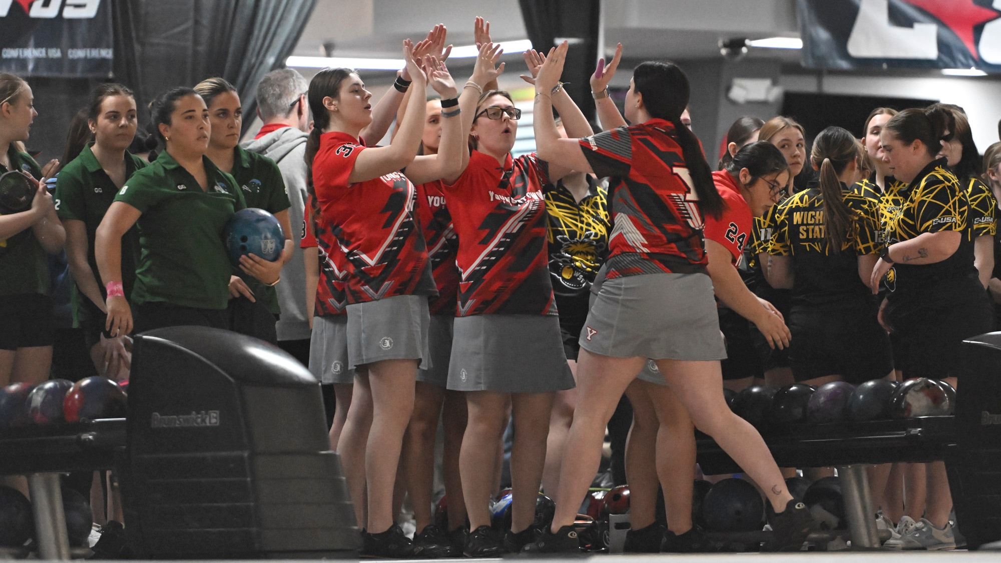 Kara Beissel high-fives her teammates at the 2026 Conference USA Bowling Championship.