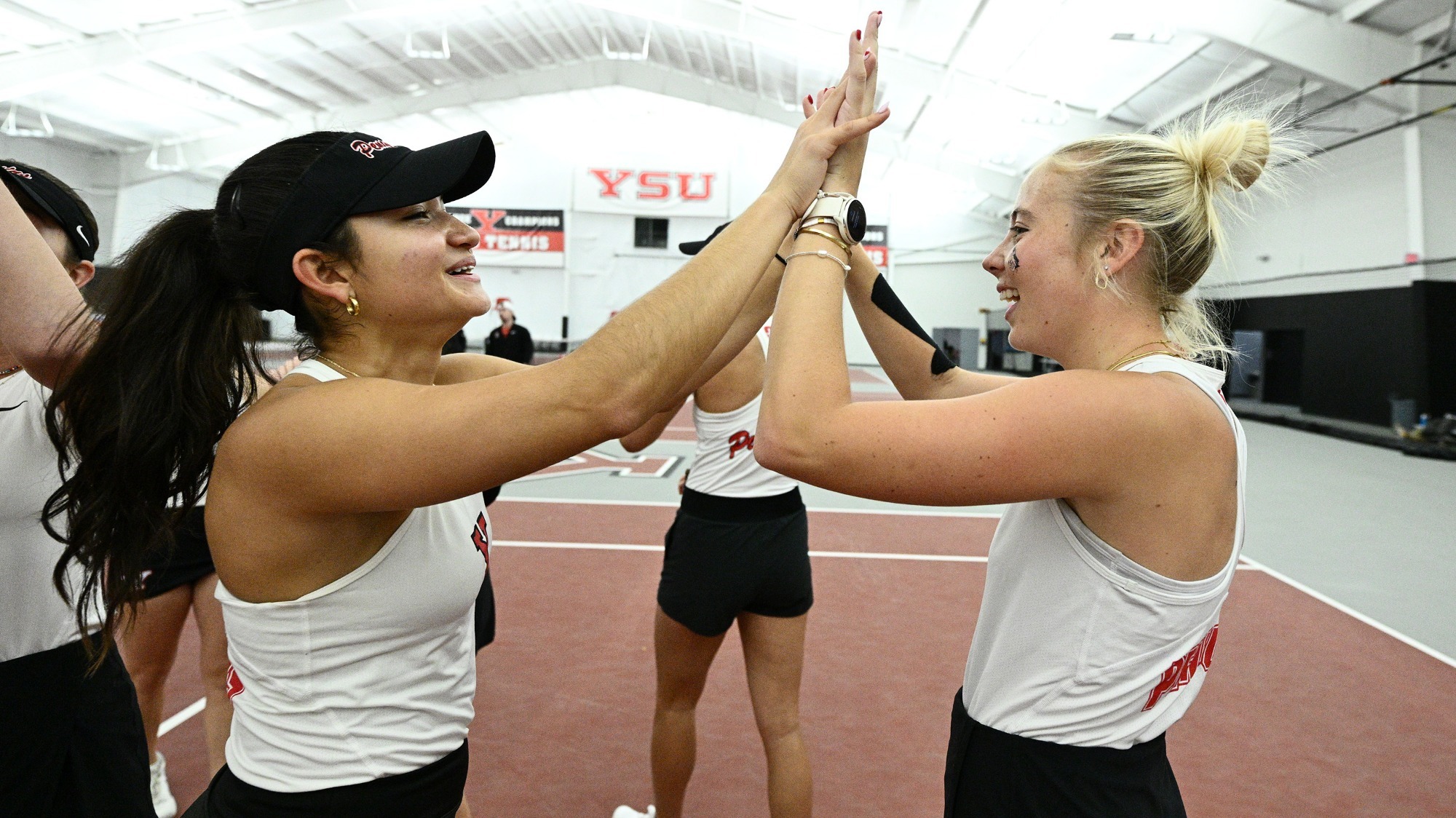 Lorena Cedeno and Line Greyling high five before a match