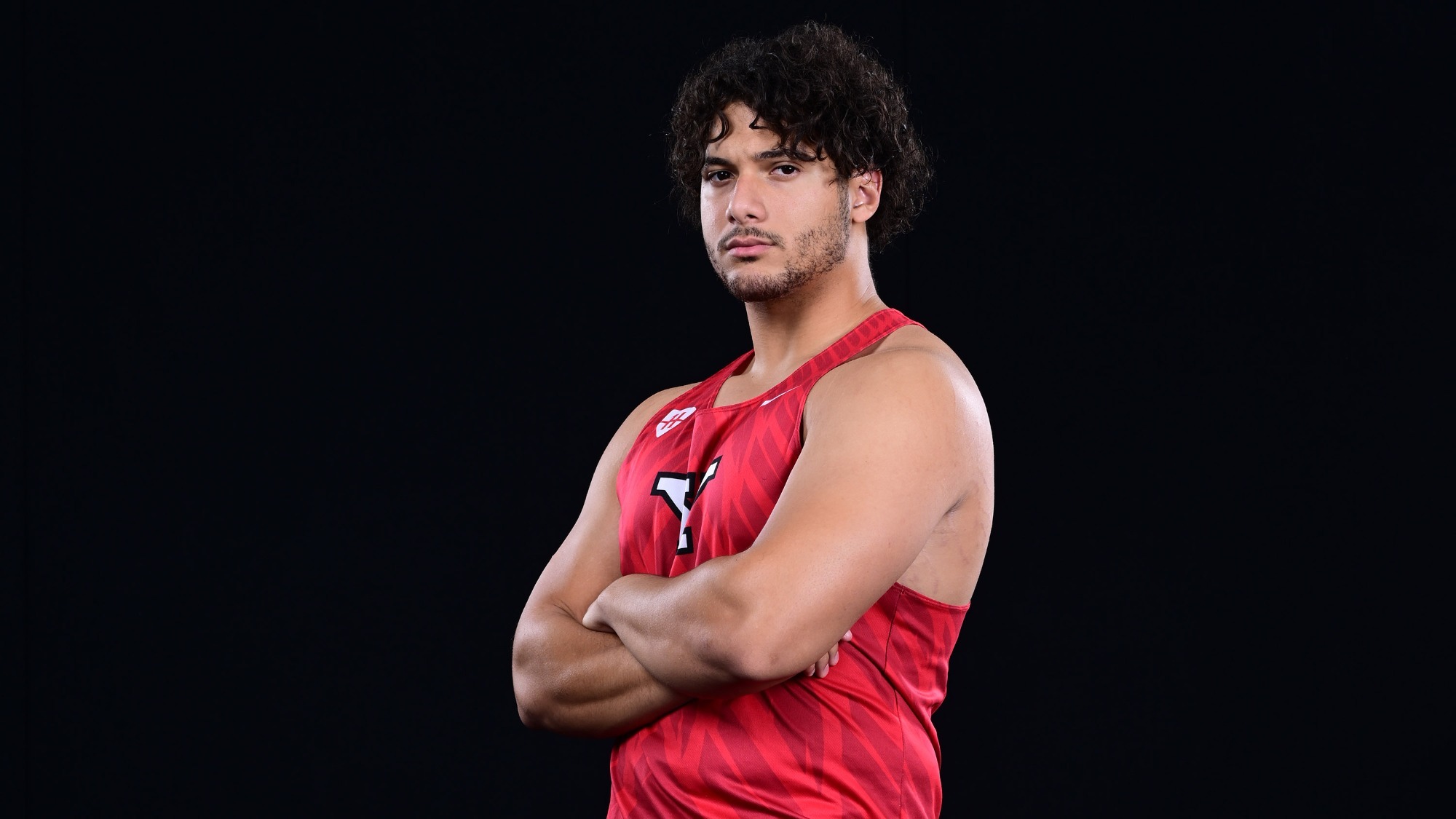 Dominic Brown poses with his arms crossed on media day