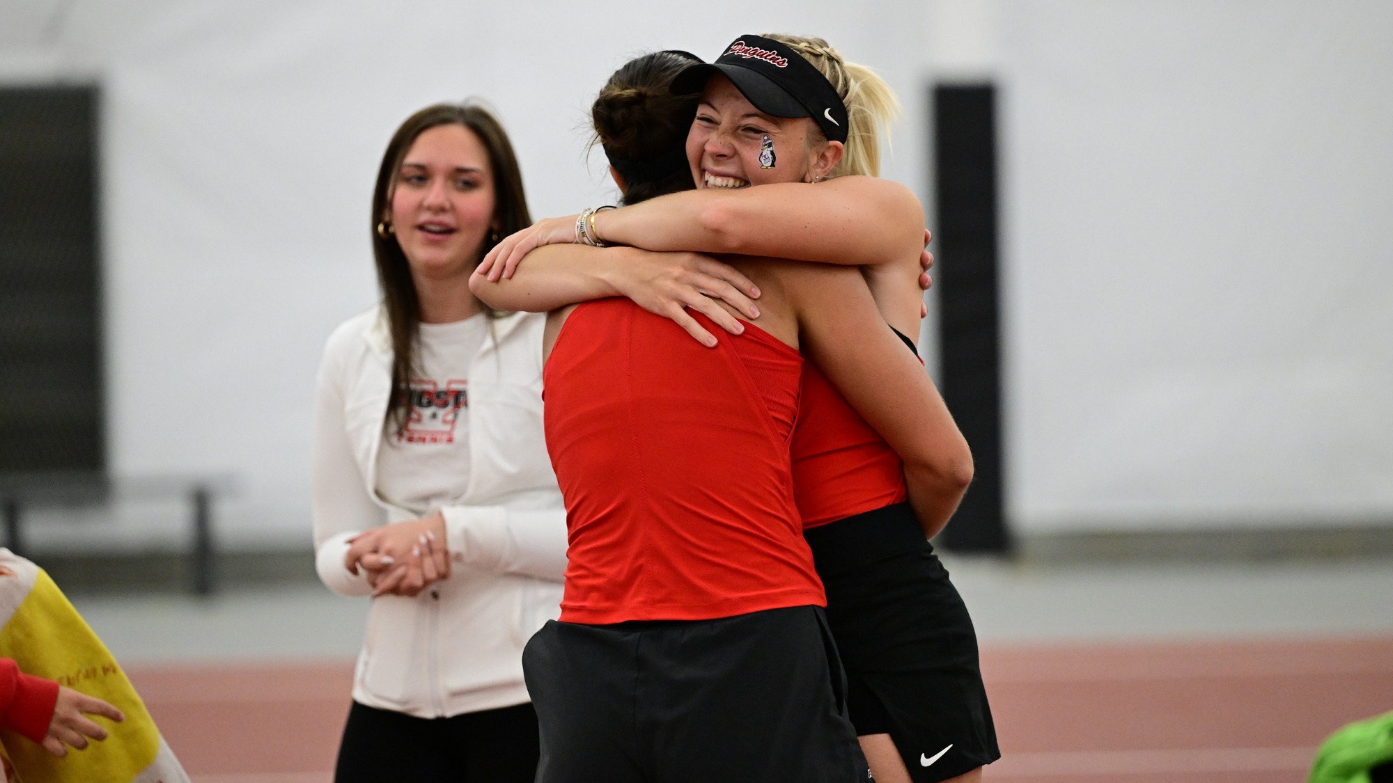Line Greyling hugs Yeseniia Ovcharova following her singles win over Cleveland State.