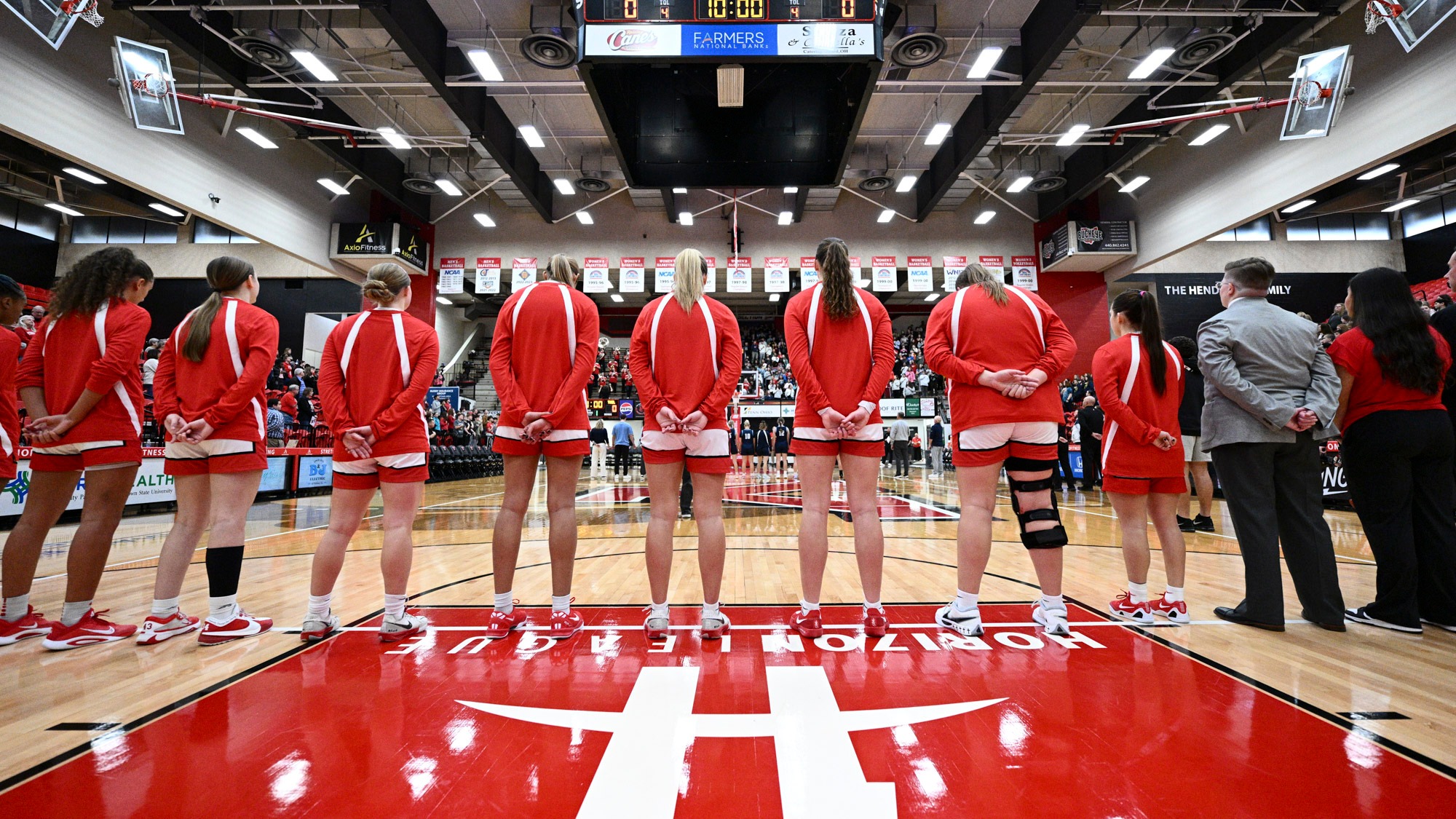 Youngstown State's women's basketball teams stands at the free throw line for the national anthem vs. Thiel on Nov. 3, 2025. Photo by Robert Hayes.