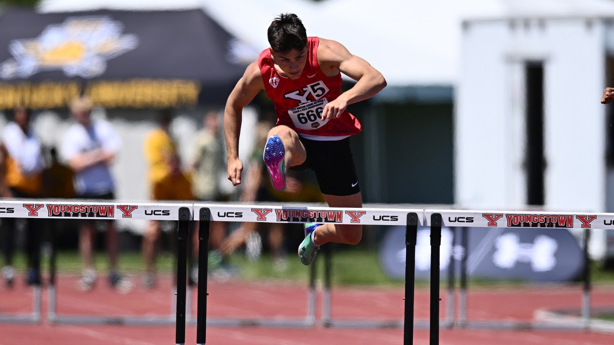 Michael Ballone jumps a hurdle during a race last May
