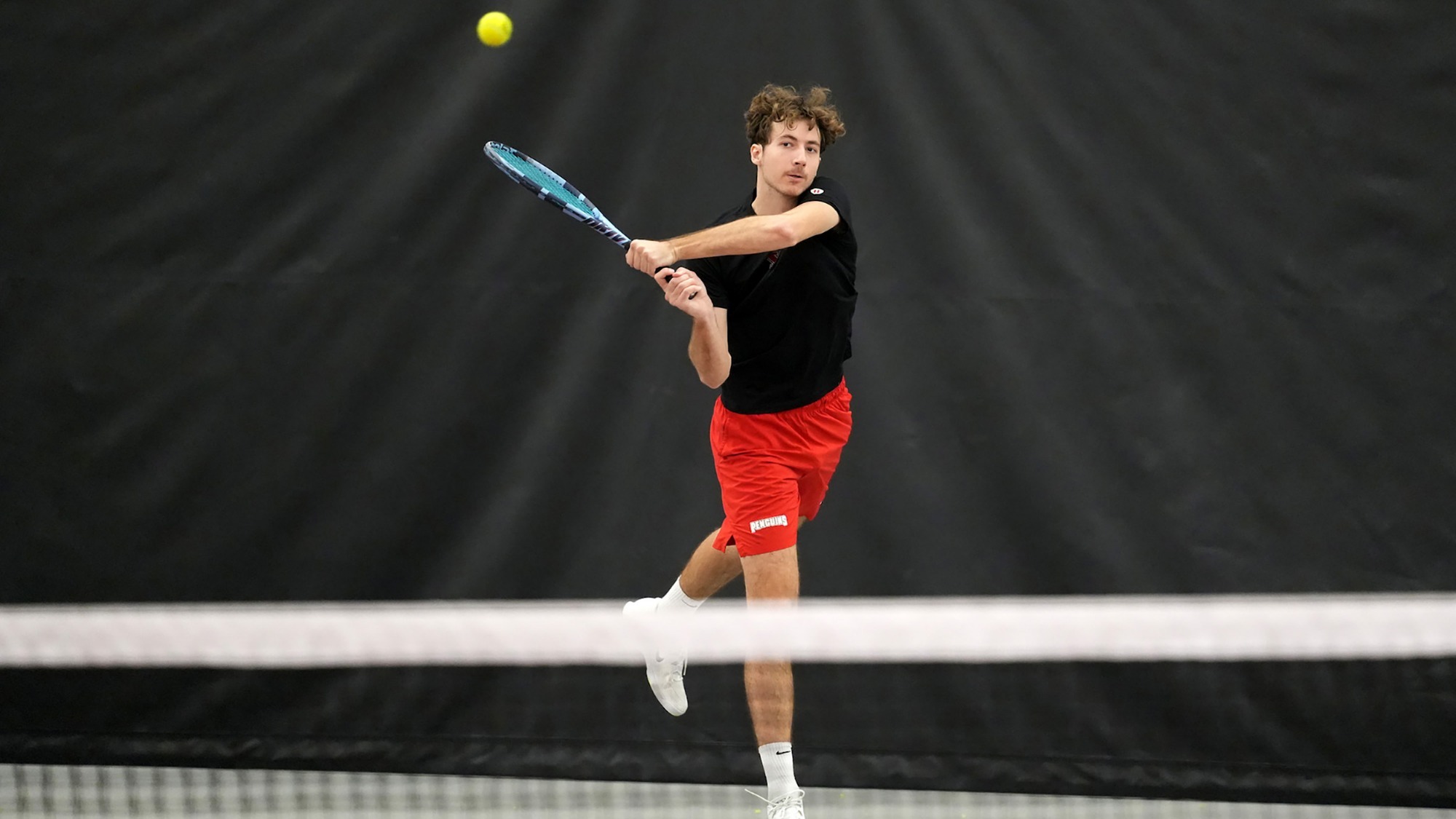 Alexis Maulouet returns a tennis shot from the baseline