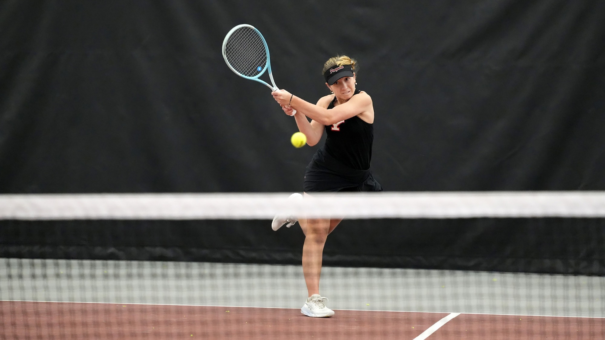 Hanna Telzynska returns a tennis shot from the baseline