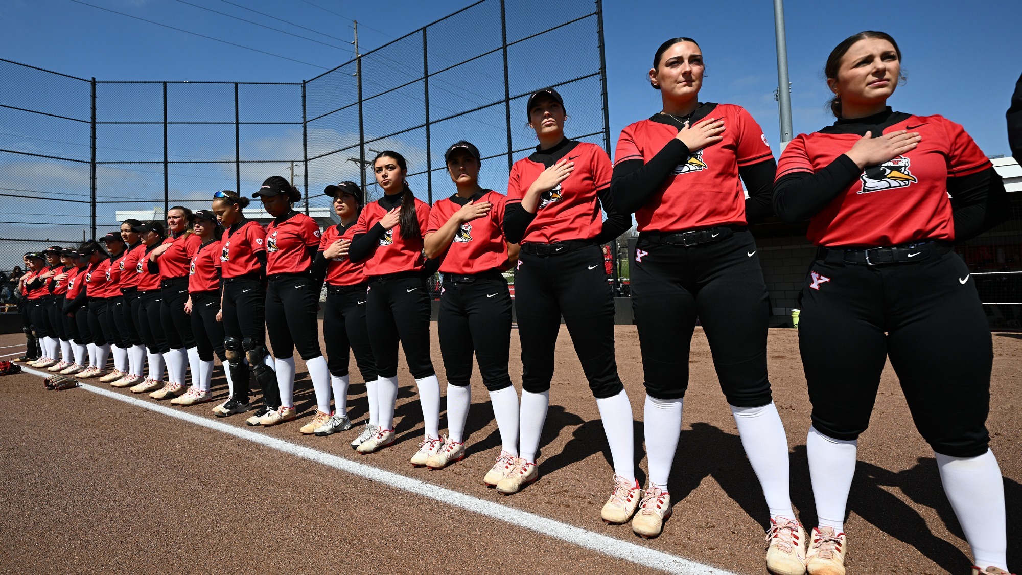 YSU Softball stands along the baseline for the National Anthem