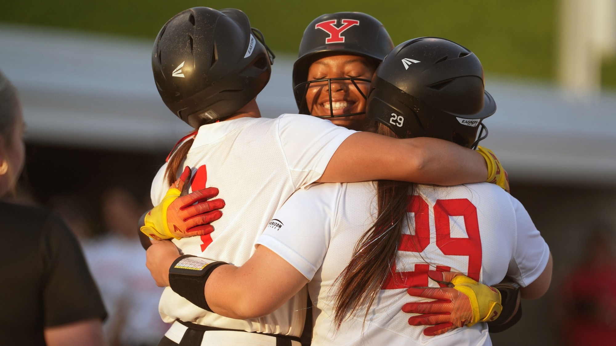 Tai Turner hugs teammates Kennedy Dean and Emma Gilkerson after hitting her fifth home run of the year.