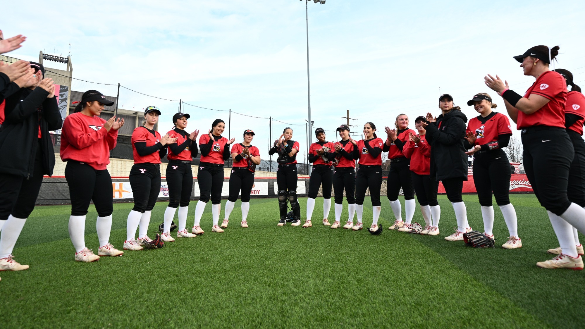 Members of the Youngstown State softball team clap and sing the YSU Fight Song after a victory over Detroit Mercy on March 21, 2026