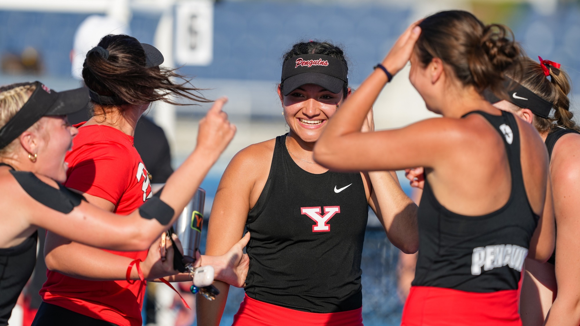 YSU Women's Tennis celebrates an HL semifinals win over Milwaukee