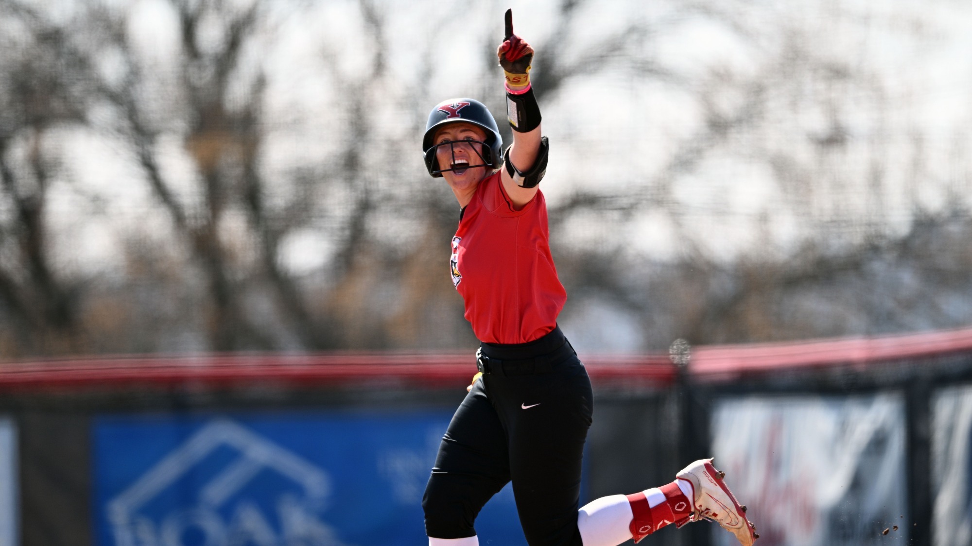 Kennedy Dean points to the dugout after launching a home run.