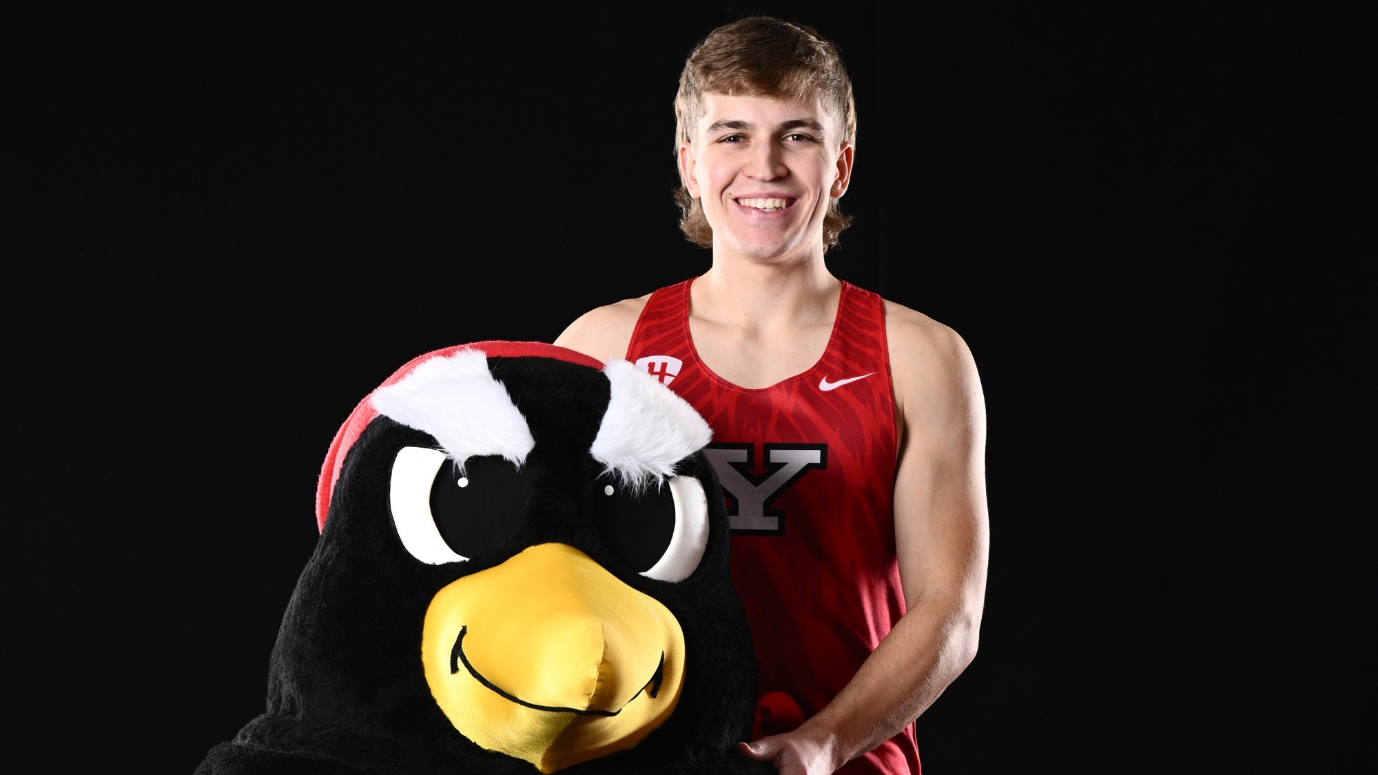 Lukas Lang poses with a Pete The Penguin mascot head