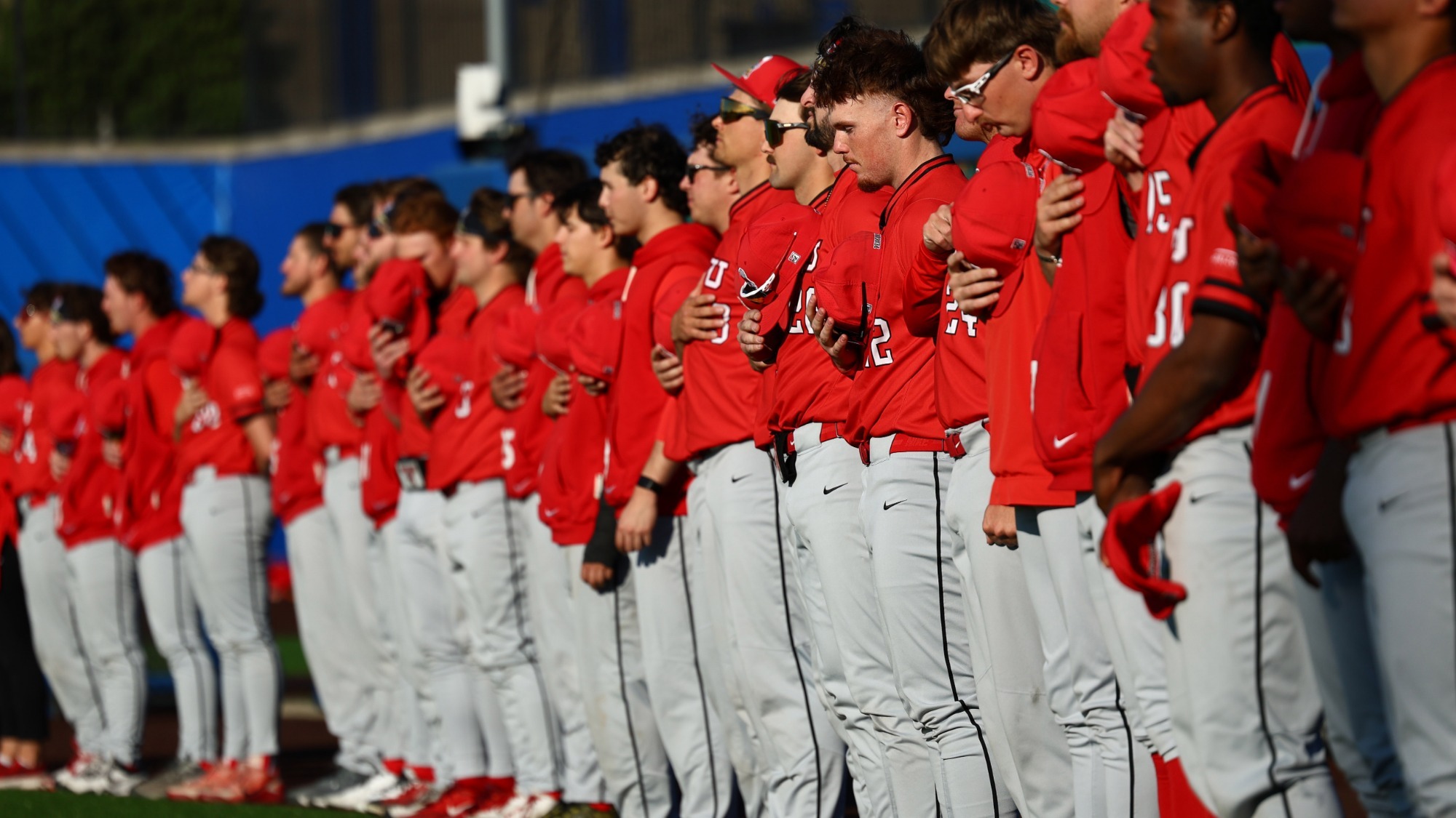 YSU baseball players stand for the National Anthem prior to a game at Pitt on April 8, 2026 (Photo by Bryson Chavez)