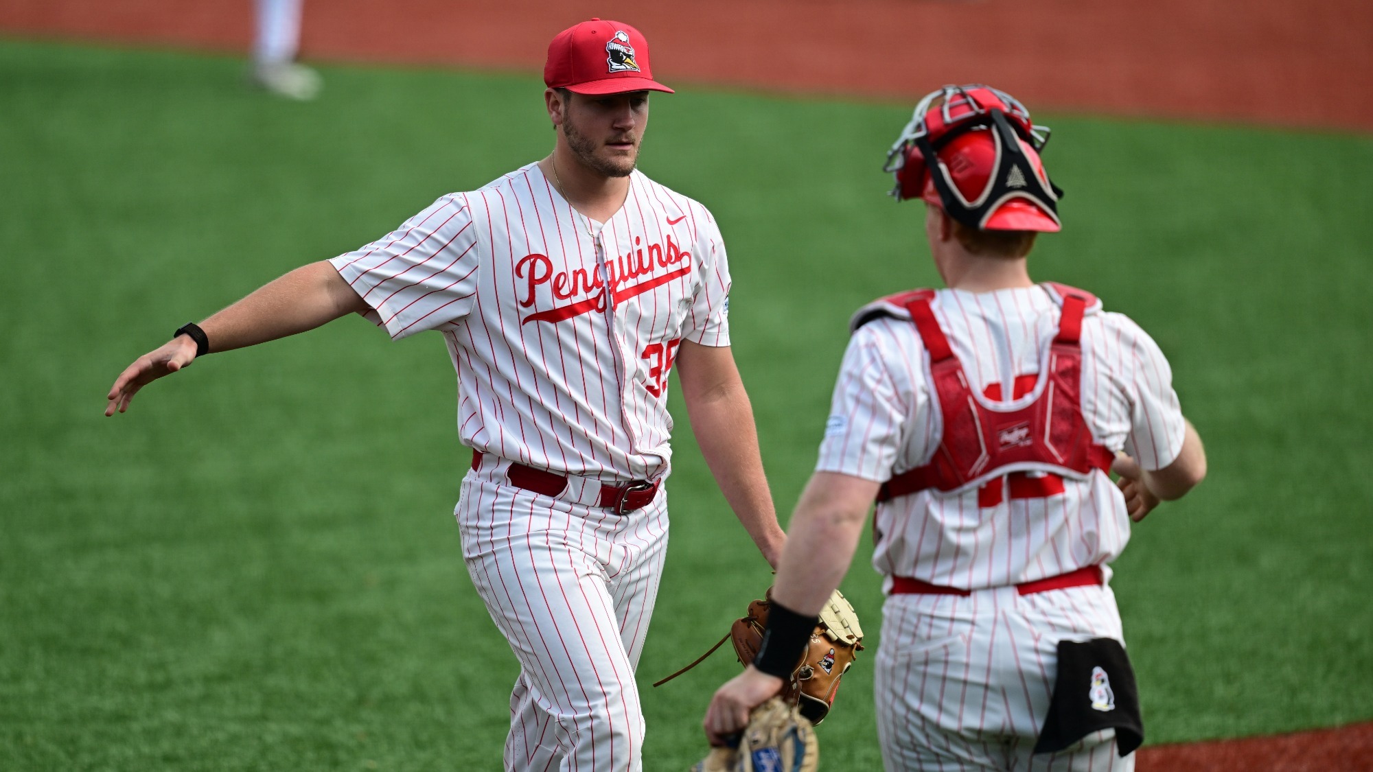 Braden Gebhardt greets a teammate walking off the mound during a YSU baseball game vs. Milwaukee on May 8, 2026 (Photo by Dave Dermer)