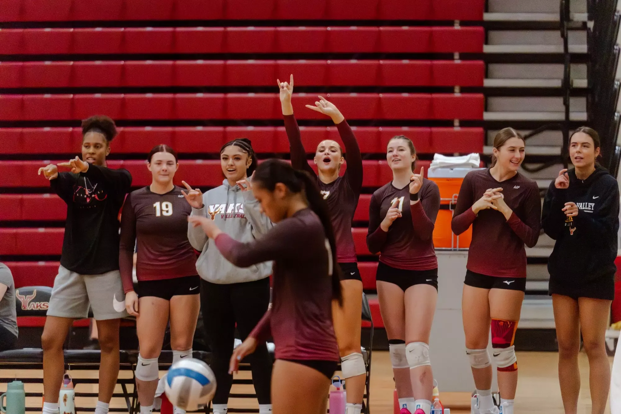 Joleen Jaeger preps to serve while her teammates cheer